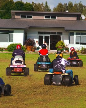 A few drivers participating in a lawnmower race