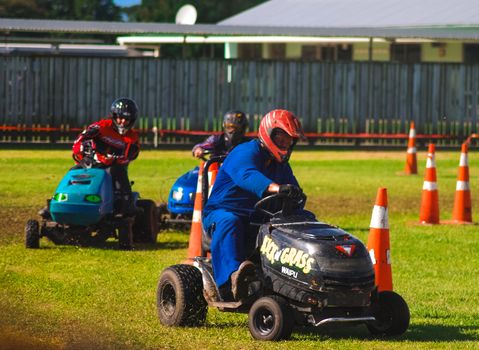 A few drivers participating in a lawnmower race