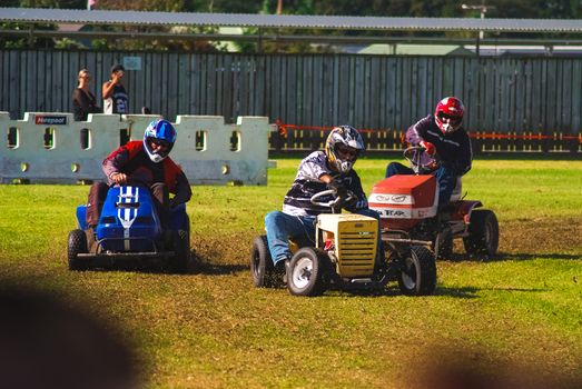 A few drivers participating in a lawnmower race