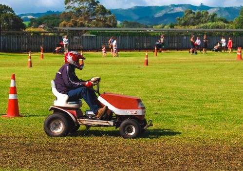 A driver participating in a lawnmower race