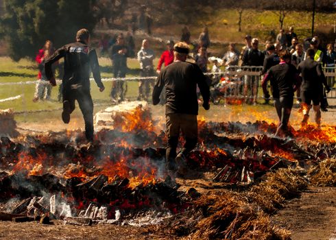 People jumping over fire in a race