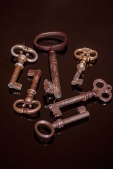 Six old rusty keys with reflections