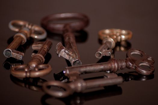 Six old rusty keys with reflections