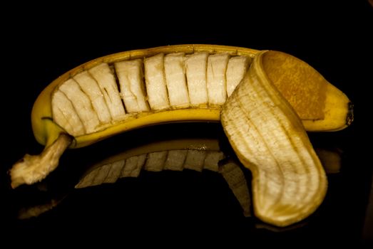 A cut banana still in its peel