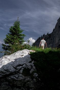 A young adventurer walking on the mountainside