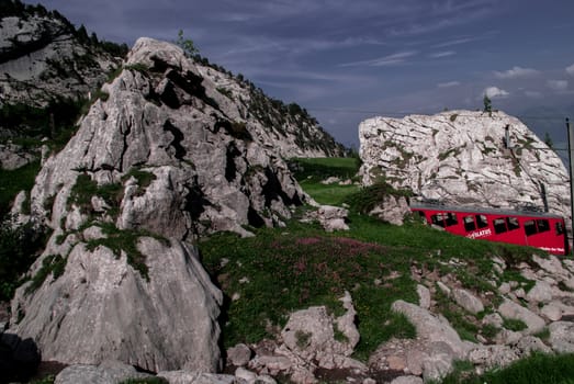 A red train going up the mountain