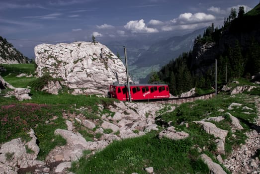 A red train going up the mountain