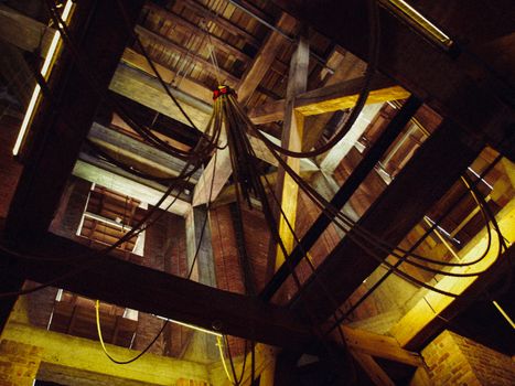 Belfry interior in old village bell tower, wooden beams, stair, bells at Netherlands