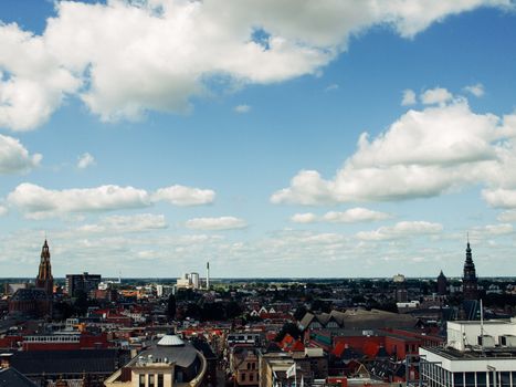 View over historic part of Groningen city under blue sky with clouds, Netherlands