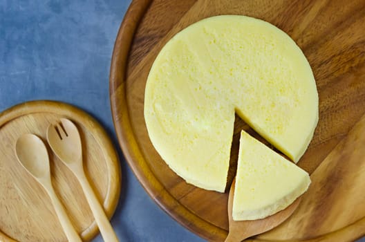 Tasty homemade cheesecake on wooden plate