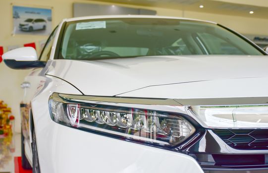 Close up shot of headlight in luxury white car background. Modern and expensive sport car concept