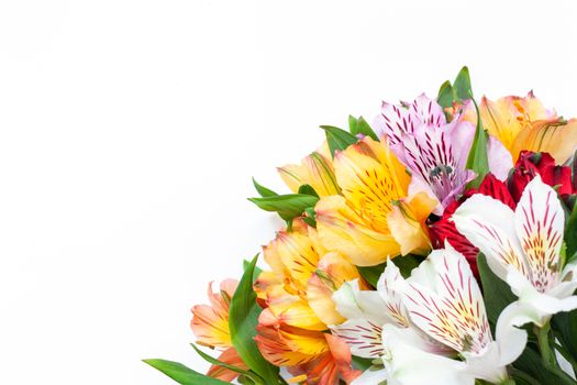 Bouquet of colorful flowers alstroemeria on white background. Flat lay. Horizontal. Mockup with copy space for greeting card, social media, flower delivery, Mother's day, Women's Day