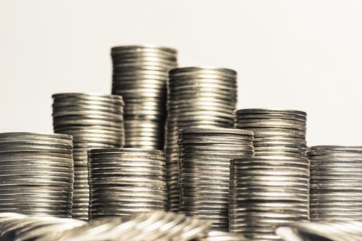 A lot of coins, selective focus.Front view of stacks of Euro coins.Concept photo.Coins close-up on the table. Simple and minimalistic design .