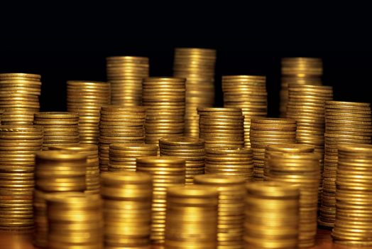 A lot of coins, selective focus.Front view of stacks of Euro coins.Concept photo.Coins close-up on the table. Simple and minimalistic design .