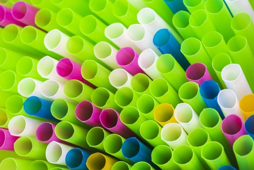 Abstract colorful background. Background from cocktail tubes close up. Soft focus. Cocktail tubes of different colors close up.Close-up of straw tubes.