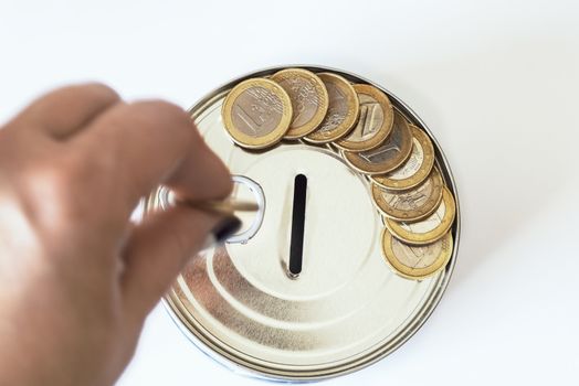 TFinancial risk and safety concept.he concept of money. A piggy bank in the form of a tin can and, next to the piggy bank, money bills and coins are laid out.