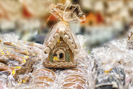 Gingerbread house wrapped. Lots of gingerbread houses.Homemade Christmas Gingerbread House displayed on a table.