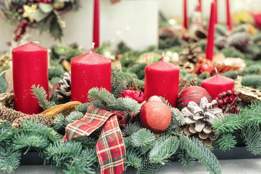 Decorative Christmas tree branches with candle ,Christmas candles decoration with flowers on a table.