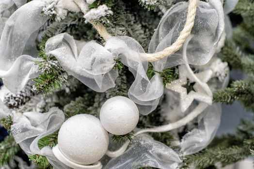 The decor on the Christmas tree on which the New Year's toys are hanging . Xmas concept. soft selective focus