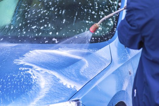 Cleaning Car Using High Pressure Water.Manual car wash with pressurized water in car wash outside.