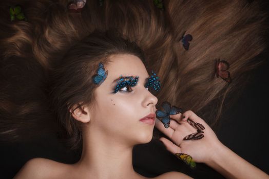 Girl with butterflies.Beautiful girl with butterflies in her hair.