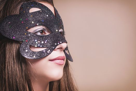 Beautiful girl in black masquerade mask.Close-up.?opy spase.