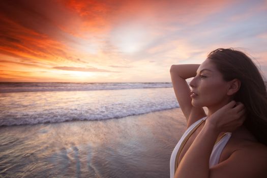 Happy woman posing on the beach at sunset, Bali, Seminyak, Double six beach