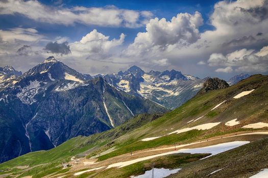 Panorama of mountains scene with dramatic blue sky in national park of Dombay