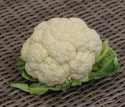 Close up of Ripe White cauliflower vegetables bundles on wooden table background