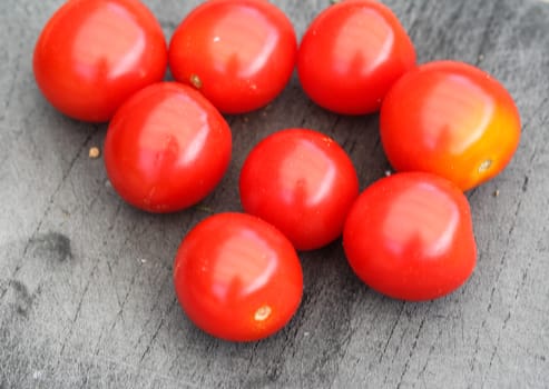 Close up of Fresh red cherry tomato on black cutting board background