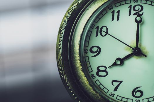 Closeup pocket watch on table and sunlight. At 8 am. o'clock in the morning. Concept of starting work today.