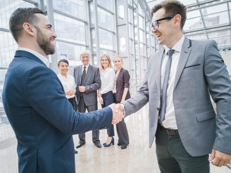 Handshake of business people in the lobby of an office building