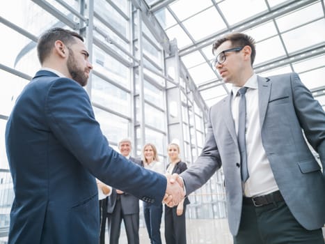 Handshake of business people in the lobby of an office building