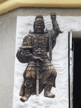 Warrior relief at the entrance of a Buddhist temple, Vietnam