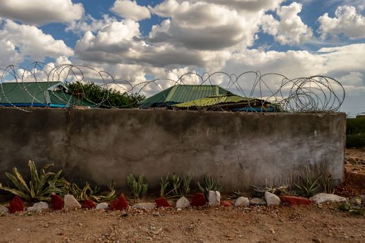 Wall and barbed wire protecting the safety of tourists in a lodge in Samburu Park, Kenya