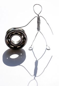 Man made from aluminum wire near ball bearing