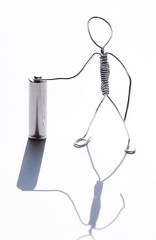 Man made from aluminum wire near old small battery