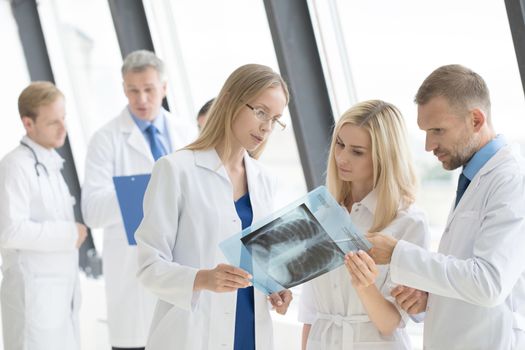 Clinic, people, healthcare and medicine concept - group of medics with chest x-ray scan at hospital