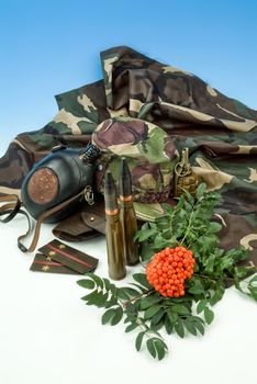 Flowers and army equipment on a studio background