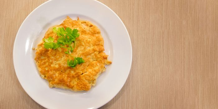 Homemade Omelette with topped with Coriander on a Round Dish