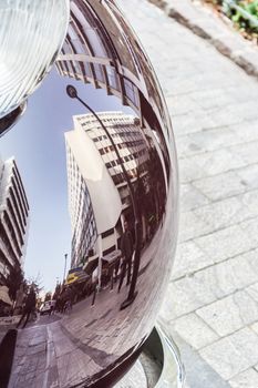 Reflection of a street building on a purple, polished old car, nice mirrored perspective of a cityscape