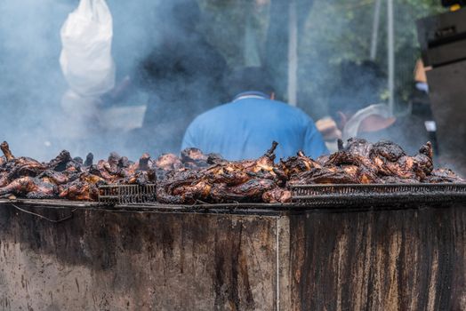 Smoky chicken BBQ is preparing on the Notting Hill carnival in London, United Kingdom