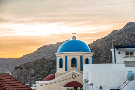 Sunset behind the an Orthodox church on a nice summer day in Serifos Island, Cyclades, Greece