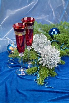 Glasses with wine on a decorative fabric background