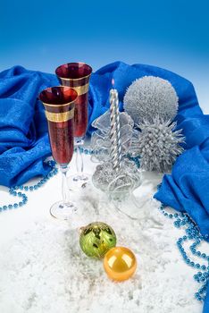 Glasses with wine on a decorative fabric background