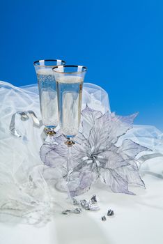 Glasses with wine on a decorative fabric background
