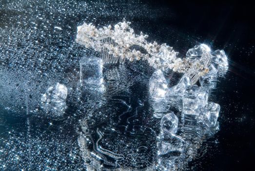 Jewelry and crystals of ice on a glass background