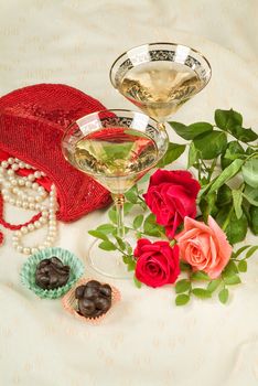 Glasses with wine on a decorative fabric background