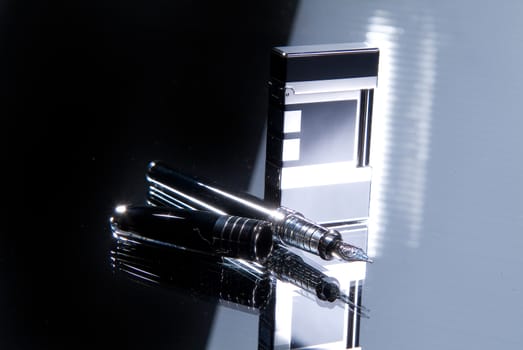 Lighter and pen on a glass background
