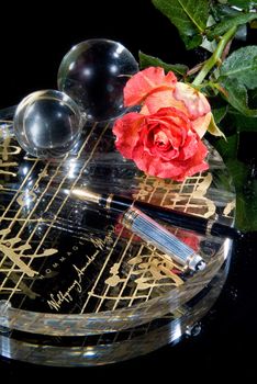 Pen and flowers on a glass studio background